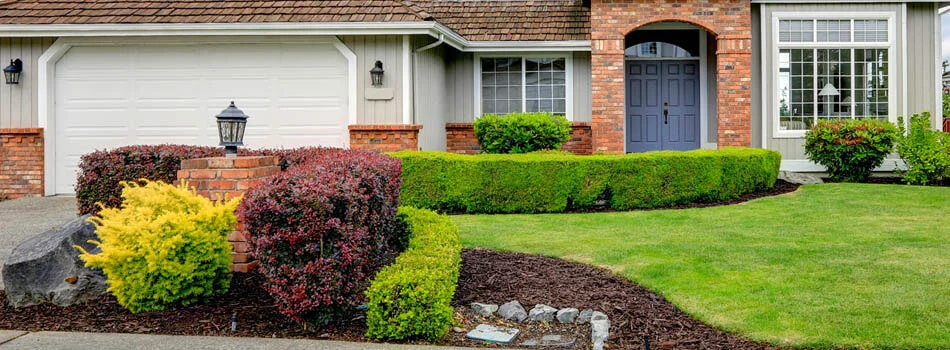 Home with trimmed shrubs and hedges in Sudbury, ON.